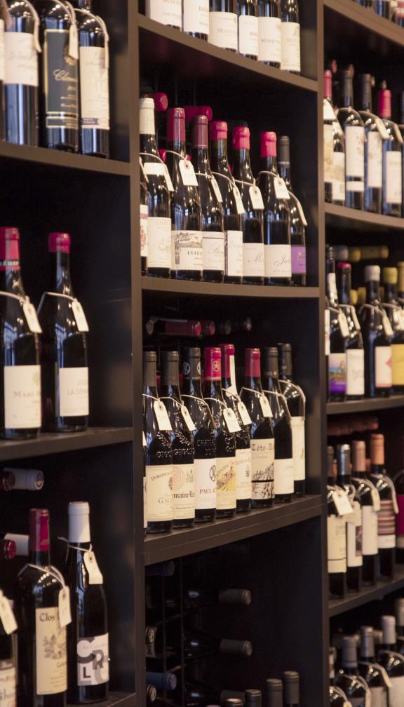 Shelves filled with bottles of wine perfectly aligned