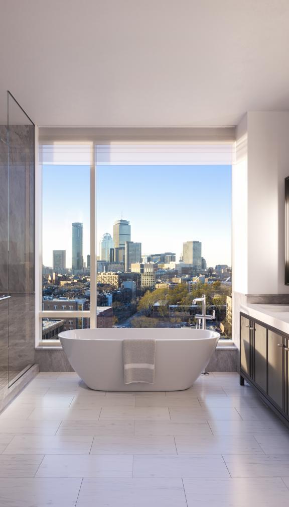 The Quinn penthouse bathroom and soaking tub with a breathtaking view of the city of Boston
