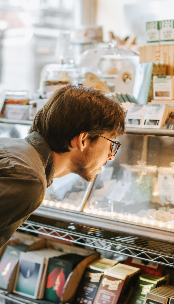 man looks into display case