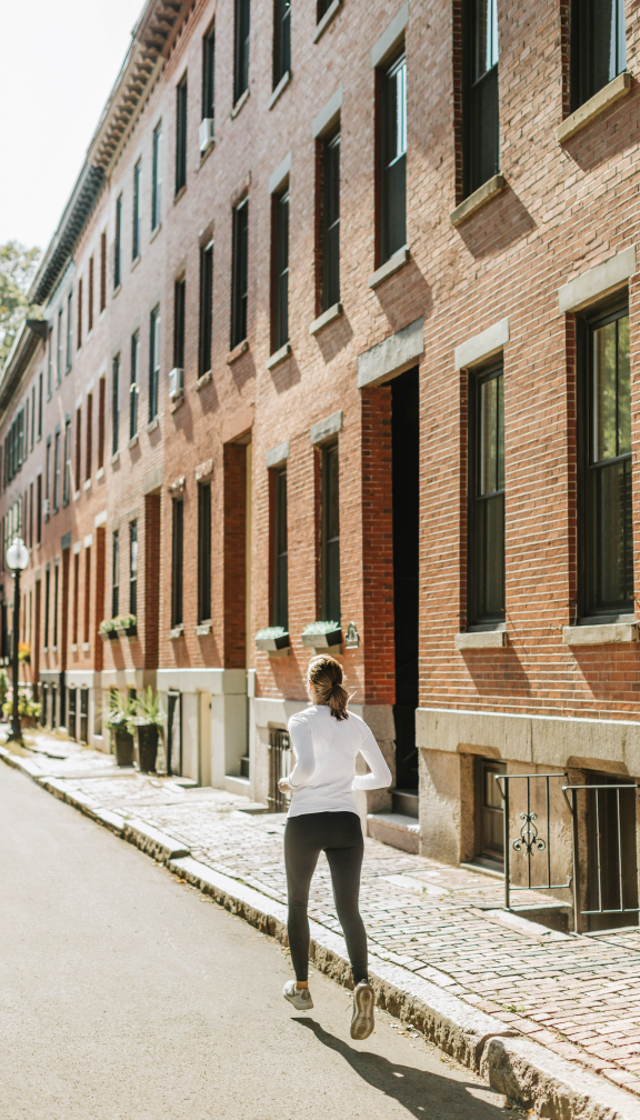 woman runs along street