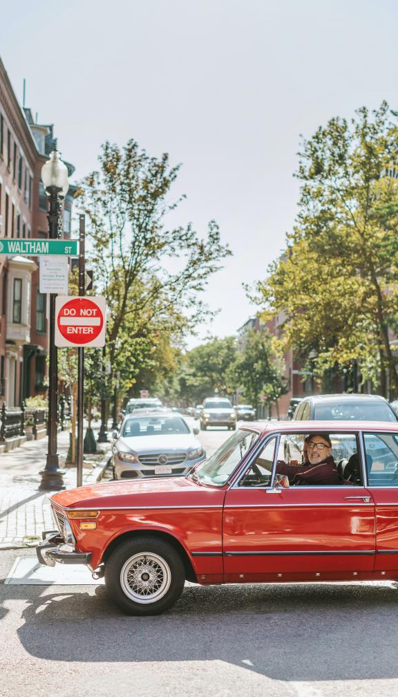 man sits in car