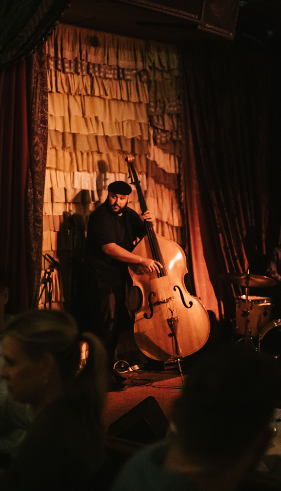 man plays instrument on stage